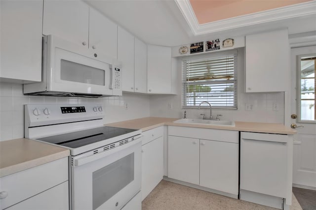 kitchen featuring a sink, white appliances, a wealth of natural light, and white cabinetry