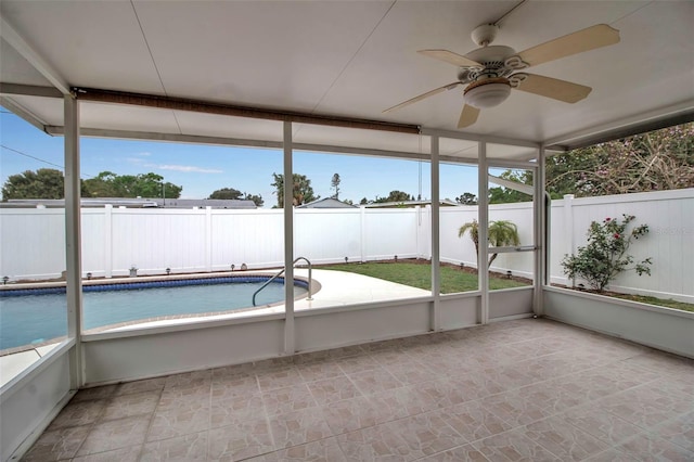 unfurnished sunroom featuring a ceiling fan