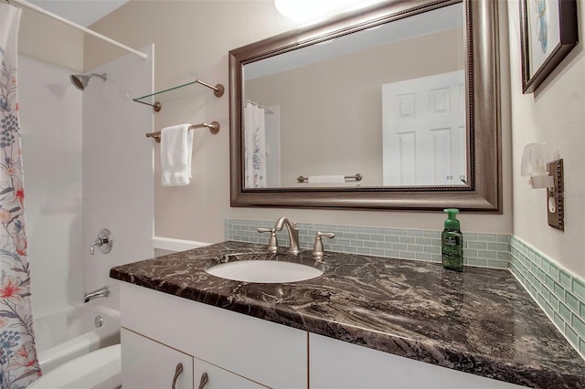 bathroom with decorative backsplash, vanity, and shower / bath combination with curtain