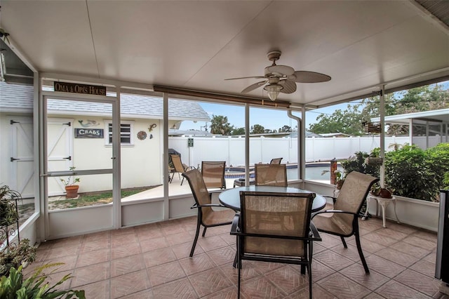 sunroom featuring a wealth of natural light and a ceiling fan