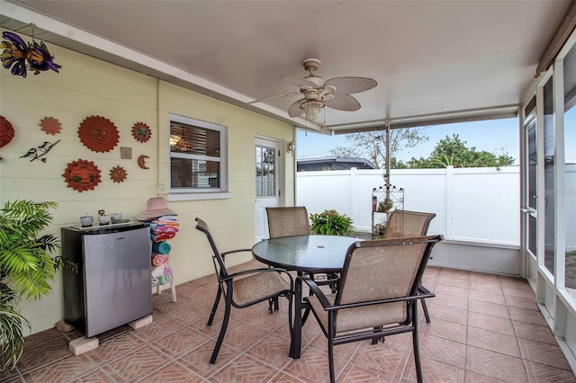 sunroom featuring plenty of natural light and ceiling fan