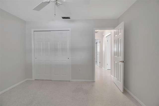 unfurnished bedroom with speckled floor, baseboards, visible vents, and a closet