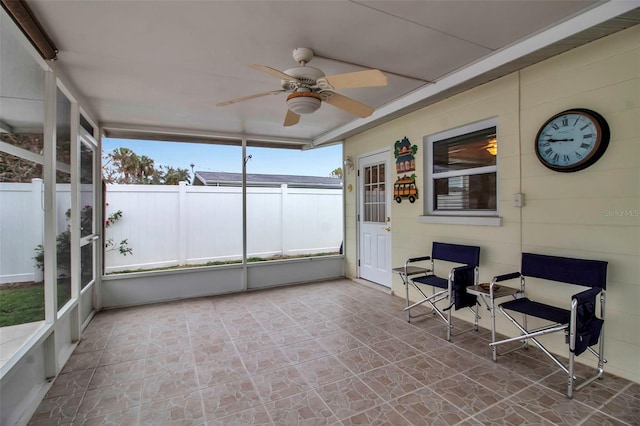 unfurnished sunroom with a ceiling fan