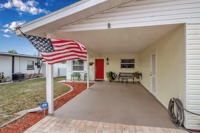 5808 18th St W Unit A & B, Bradenton, FL 34207 - view of exterior entry featuring a lawn, a carport, and central AC