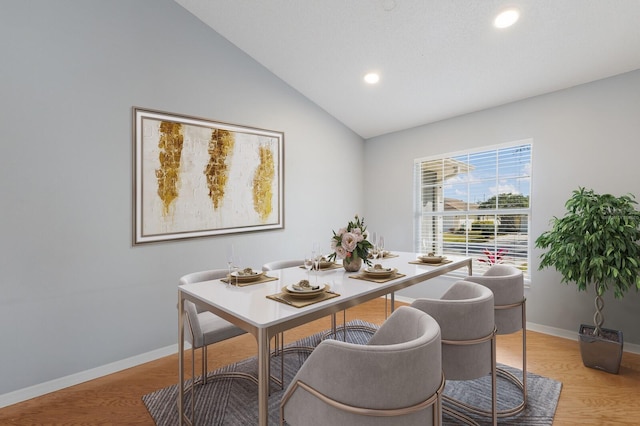 dining space featuring vaulted ceiling, recessed lighting, light wood-style flooring, and baseboards