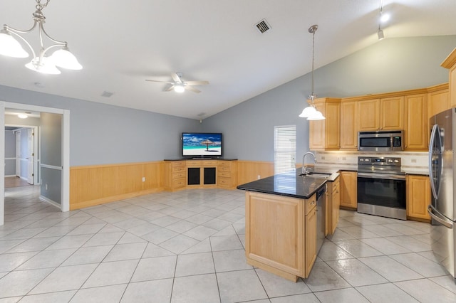 kitchen featuring light tile patterned floors, visible vents, appliances with stainless steel finishes, open floor plan, and a sink