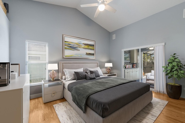 bedroom featuring access to exterior, ceiling fan, high vaulted ceiling, and light wood finished floors