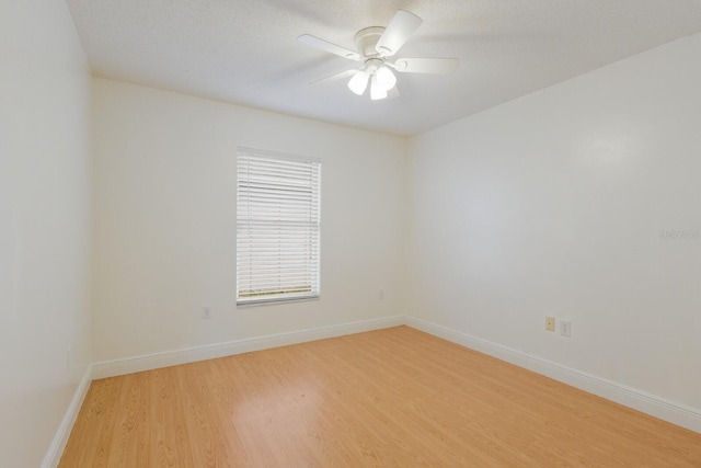 unfurnished room with a ceiling fan, baseboards, and light wood finished floors