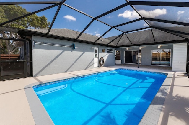 pool featuring ceiling fan, a patio, and glass enclosure