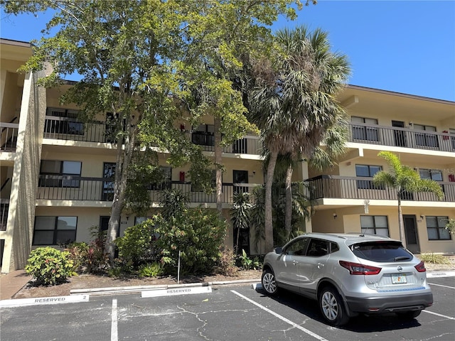 view of building exterior featuring uncovered parking