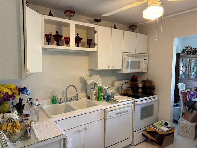 kitchen with white appliances, light countertops, a sink, and open shelves