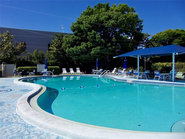 pool featuring fence and a patio