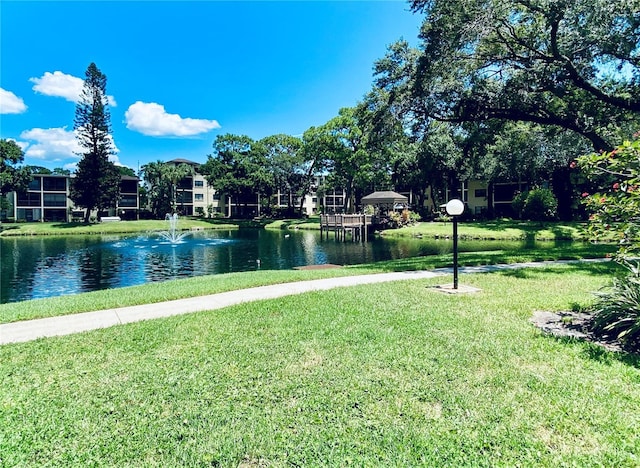 view of community featuring a water view and a lawn