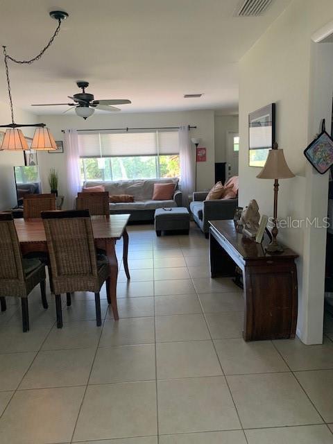 3013 Yarmouth Dr W, Bradenton, FL 34205 - dining room featuring plenty of natural light, a ceiling fan, and light tile patterned floors