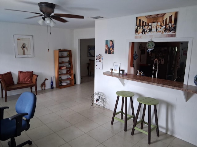 3013 Yarmouth Dr W, Bradenton, FL 34205 - kitchen featuring freestanding refrigerator, a ceiling fan, and a kitchen bar