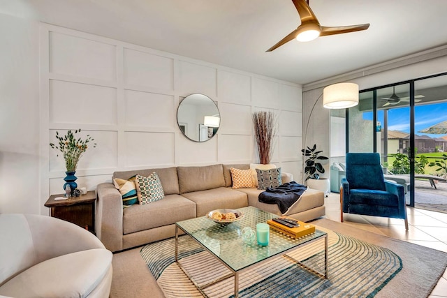 living room featuring tile patterned flooring, a ceiling fan, and a decorative wall