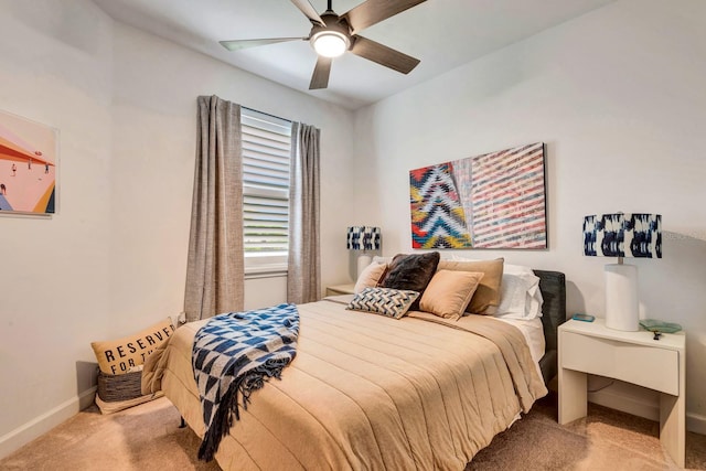 carpeted bedroom with baseboards and a ceiling fan