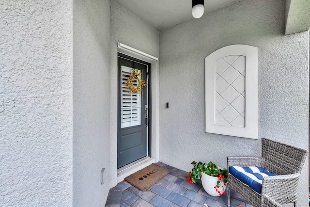 property entrance with stucco siding