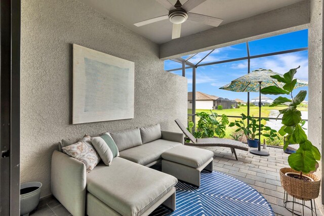 sunroom featuring ceiling fan