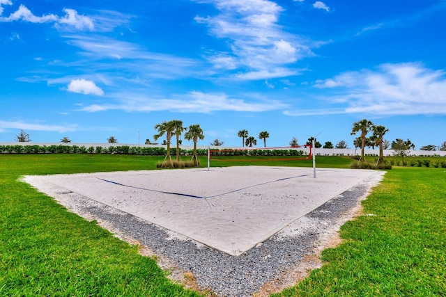 surrounding community featuring volleyball court and a lawn