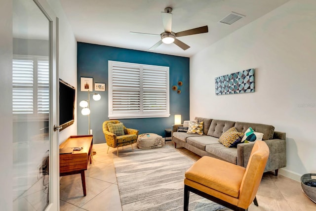 tiled living room with ceiling fan, visible vents, and baseboards