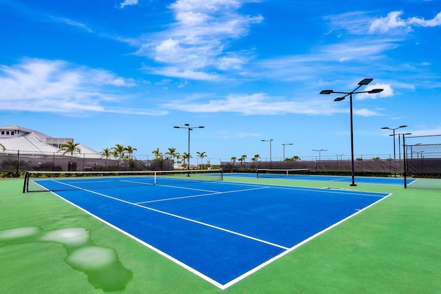 view of tennis court with fence