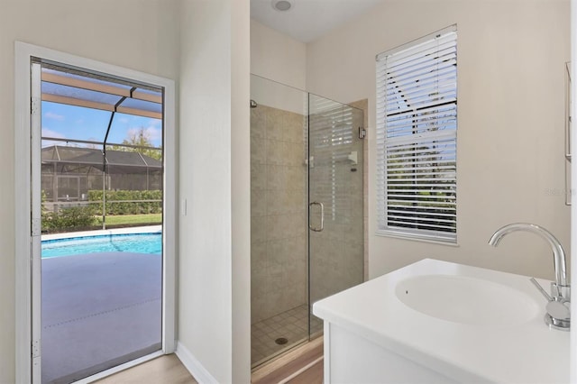 full bath with a shower stall and a sink