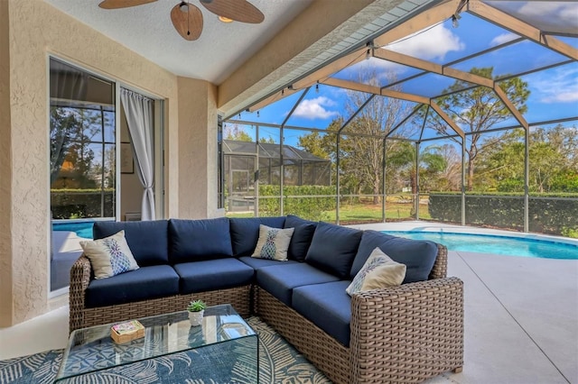 exterior space featuring an outdoor pool, glass enclosure, outdoor lounge area, and a ceiling fan