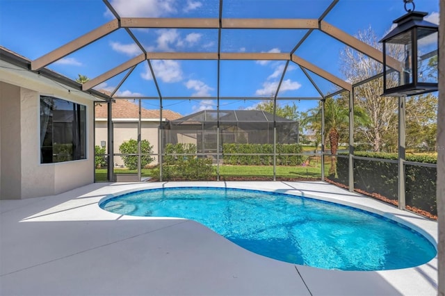 outdoor pool featuring glass enclosure and a patio area