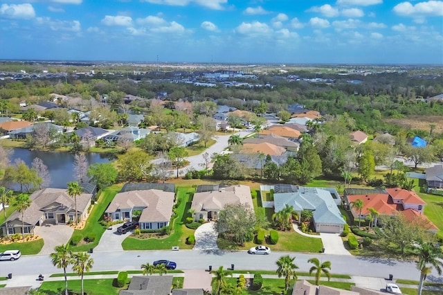 birds eye view of property featuring a water view and a residential view