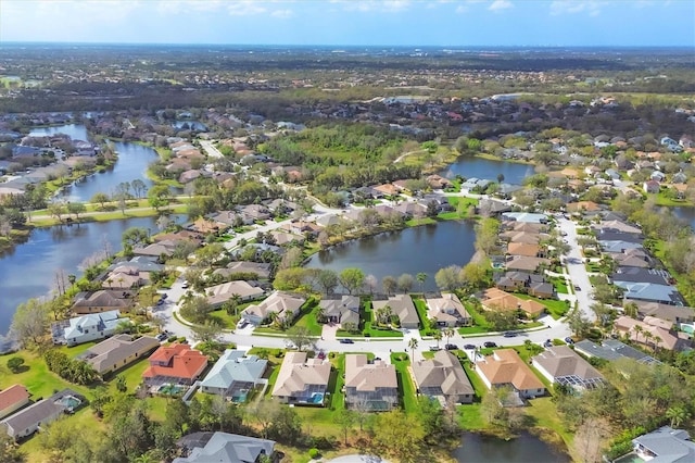 drone / aerial view featuring a water view and a residential view