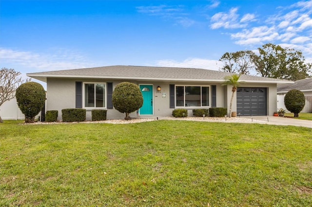 single story home featuring a front yard, concrete driveway, an attached garage, and stucco siding