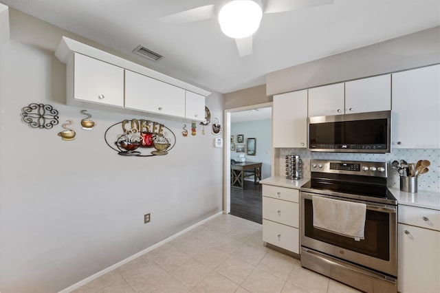 kitchen with white cabinetry, appliances with stainless steel finishes, light countertops, and decorative backsplash