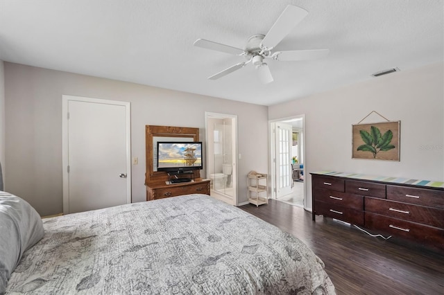 bedroom featuring ceiling fan, dark wood-style flooring, connected bathroom, and visible vents