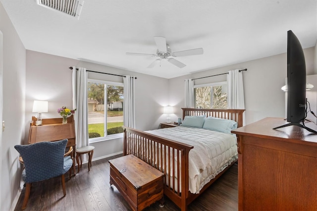 bedroom with dark wood-style floors, baseboards, visible vents, and ceiling fan