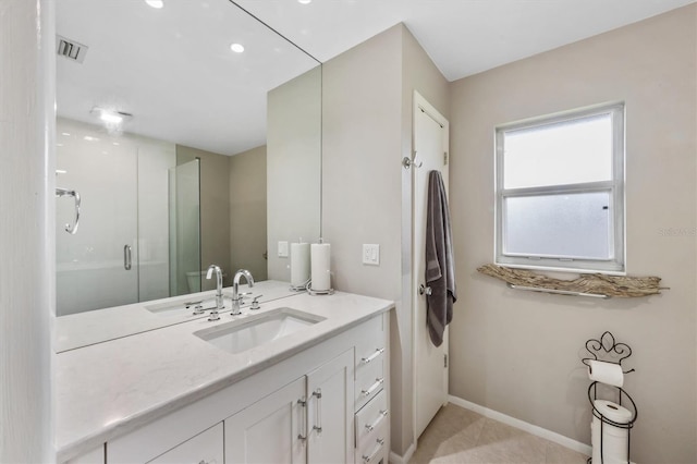 bathroom with a stall shower, visible vents, baseboards, tile patterned flooring, and vanity