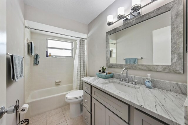 bathroom featuring tile patterned flooring, vanity, toilet, and shower / bath combo with shower curtain