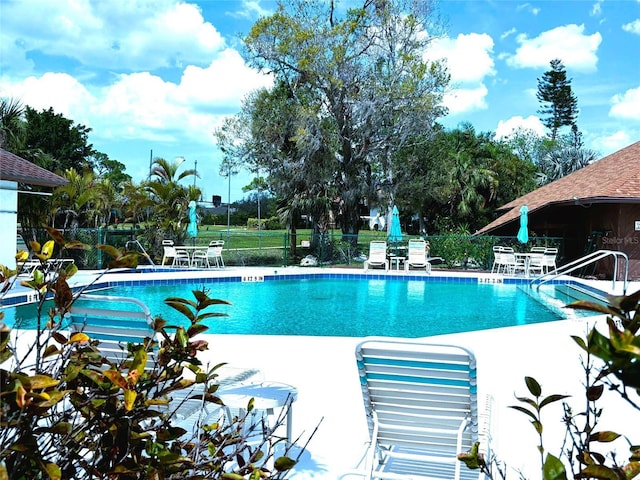 pool featuring a patio area and fence