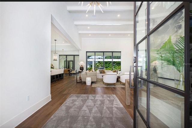 interior space featuring recessed lighting, dark wood-type flooring, baseboards, beamed ceiling, and an inviting chandelier