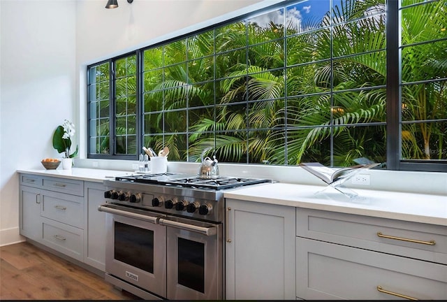 kitchen with double oven range, gray cabinets, and light countertops