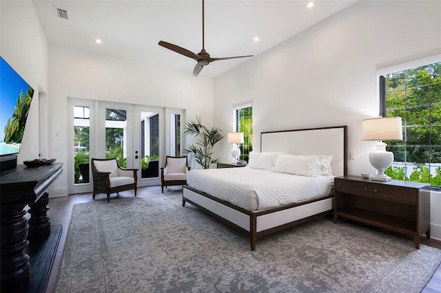 bedroom with access to exterior, visible vents, multiple windows, and wood finished floors