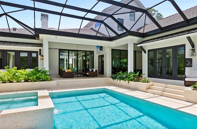 view of swimming pool with french doors, a patio area, and a pool with connected hot tub