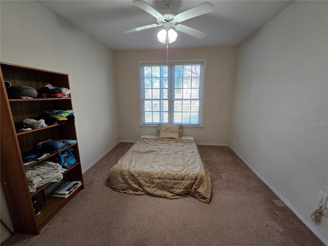 bedroom with a ceiling fan, carpet, and baseboards