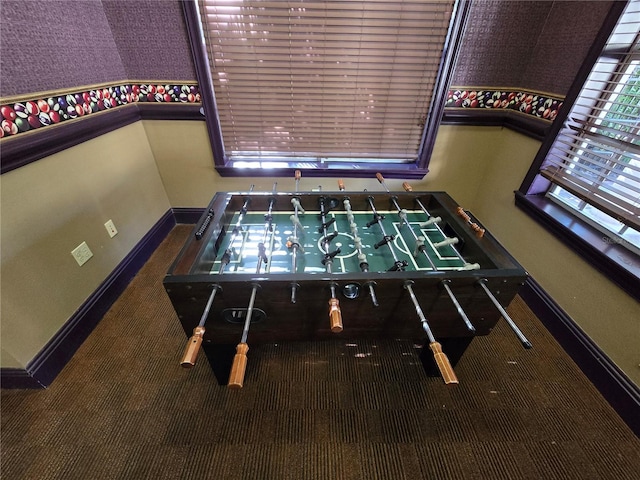 recreation room with carpet floors and baseboards