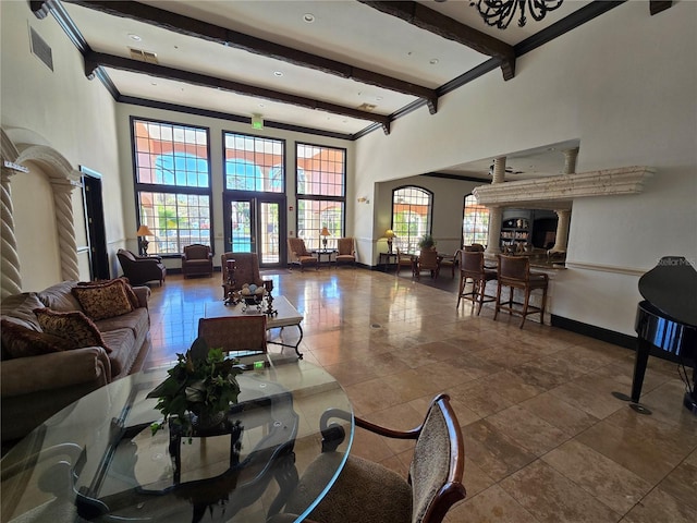 tiled living room featuring a towering ceiling, visible vents, baseboards, and beamed ceiling