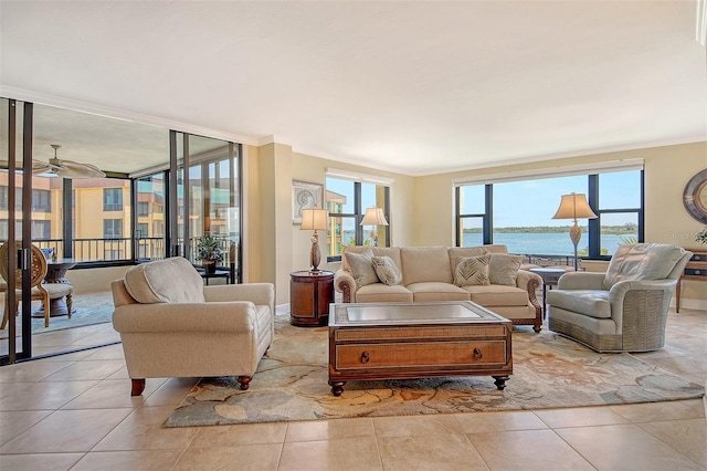 8779 Midnight Pass Rd Unit 406H, Sarasota, FL 34242 - tiled living room featuring crown molding, a water view, and ceiling fan