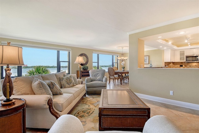 8779 Midnight Pass Rd Unit 406H, Sarasota, FL 34242 - living room featuring ornamental molding, a chandelier, light tile patterned floors, baseboards, and a water view