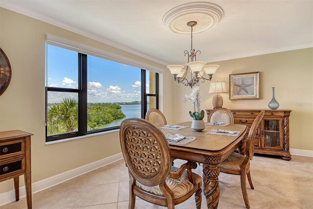 8779 Midnight Pass Rd Unit 406H, Sarasota, FL 34242 - dining area with a chandelier, baseboards, light tile patterned floors, crown molding, and a water view