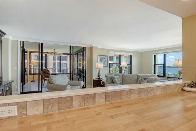 8779 Midnight Pass Rd Unit 406H, Sarasota, FL 34242 - living area with wood finished floors, crown molding, and a ceiling fan