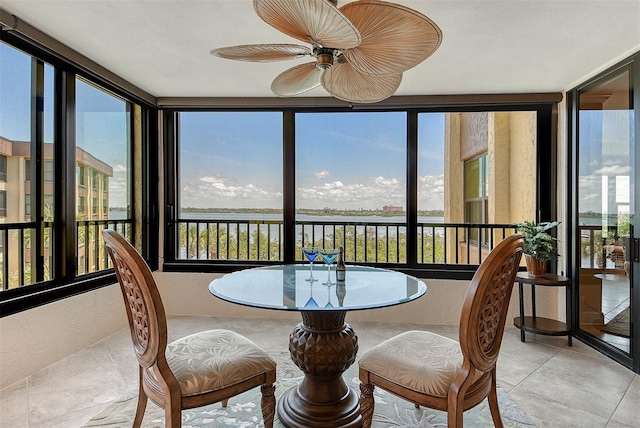 8779 Midnight Pass Rd Unit 406H, Sarasota, FL 34242 - sunroom featuring healthy amount of natural light, a water view, tile patterned flooring, and a textured wall
